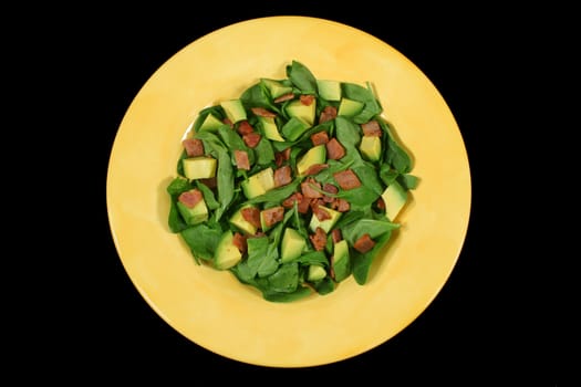 Delightful baby spinach, avocado and bacon salad ready to serve.