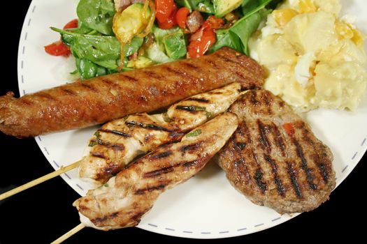 BBQ chicken tenderloin skewers, beef sausage, beef patty with spinach salad and potato salad.