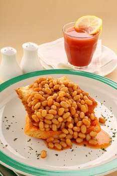 Delicious and simple old fashioned baked beans stack on toast with tomato juice.