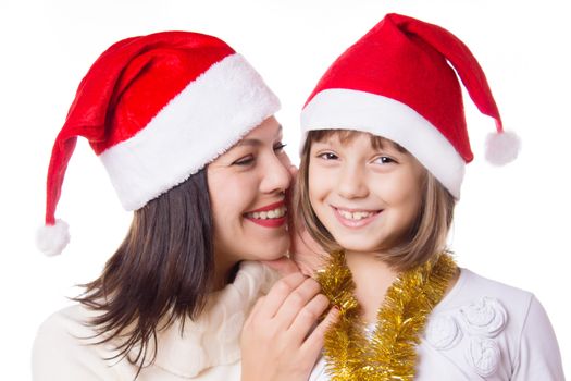 Mother and daughter sharing each other secrets on Christmas Eve over white