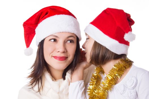 Mother and daughter sharing each other secrets on Christmas Eve over white