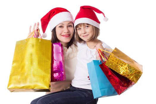 Happy mother and daughter on Christmas shopping isolated on white