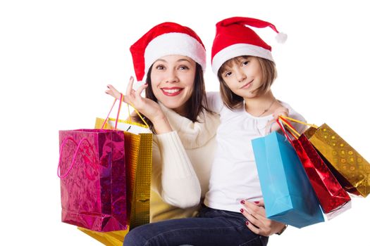 Happy mother and daughter on Christmas shopping isolated on white