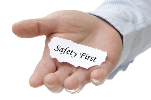 Businessman holding safety first note