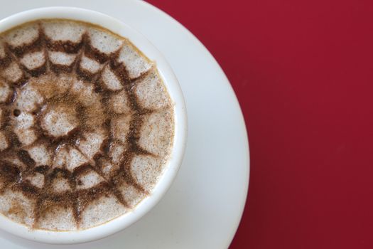 Make coffee latte with cream on red background