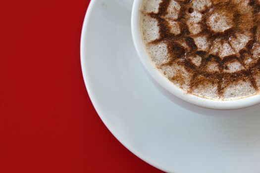 Make coffee latte with cream on red background