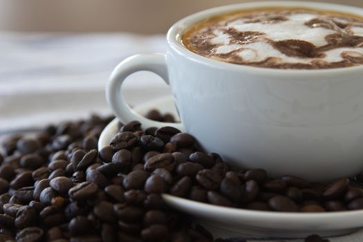 Coffee cup and beans on a white background.