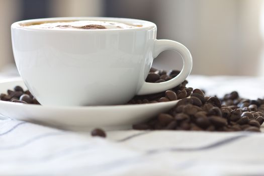 Coffee cup and beans on a white background.