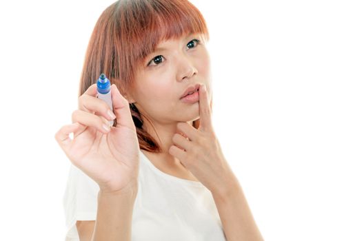 Taiwanese woman writing on futuristic board with blue marker