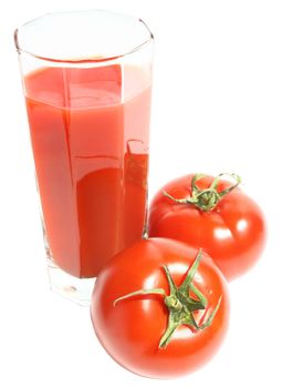 Glass of tomato juice and two tomatoes.