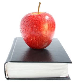 Red apple on the book.