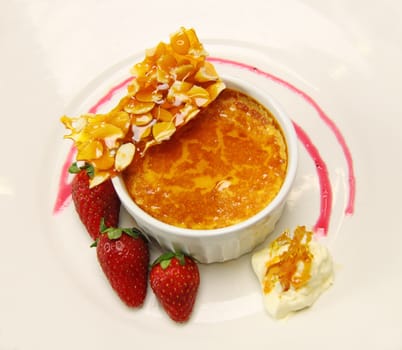 Delicious almond praline and baked custard with fresh strawberries and cream.