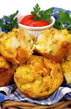 Freshly baked vegetable muffins with one cut in half.