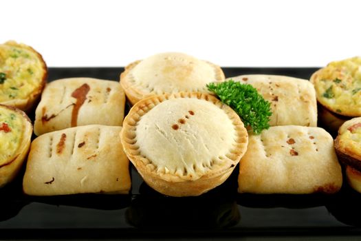 Delicious home baked snack size meat pies, sausage rolls and quiches.