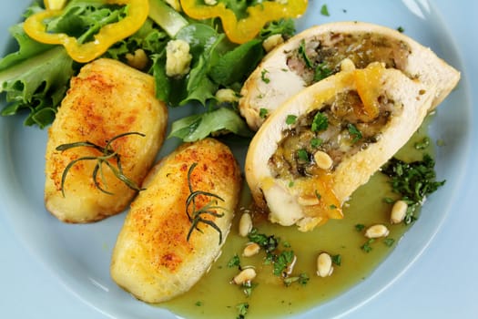 Delicious stuffed chicken and potatoes and salad with a piquant sauce.