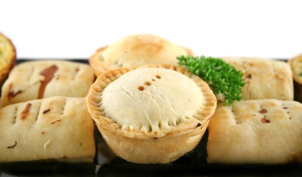 Delicious home baked snack size meat pies, sausage rolls and quiches.