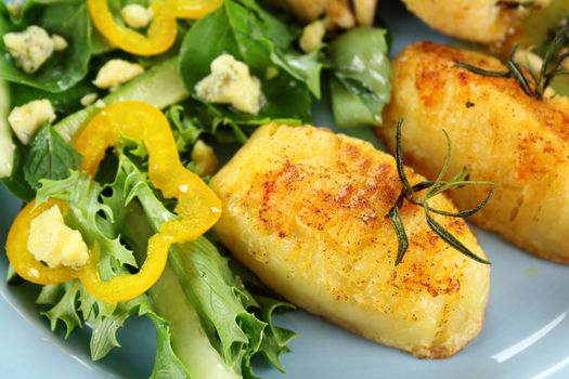 Fresh baked potato with rosemary and salad.