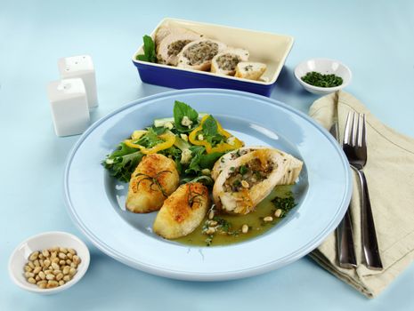 Delicious stuffed chicken and potatoes and salad with a piquant sauce.