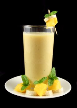 Freshly mixed banana and mango smoothie ready to serve.