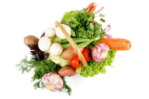 Basket of Various Vegetables with Greens, Bell Pepper, Carrot, Onion, Garlic, Parsley, Potato, Tomatoes, Cabbage, Basil and Edible Mushrooms isolated on white background. Top View