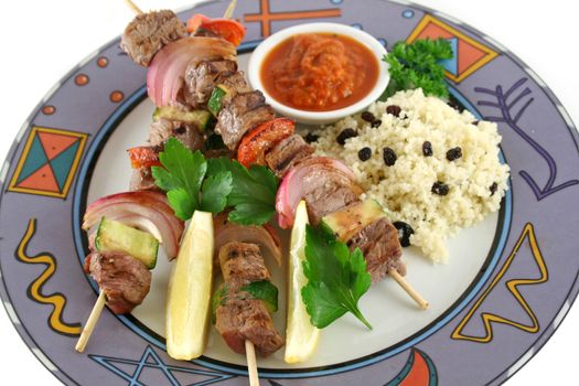 Beef kebabs and currant couscous with harissa sauce.