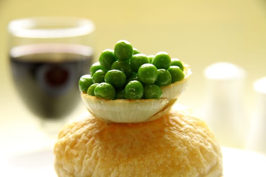 Green peas cupped in onion rings on top of pastry.