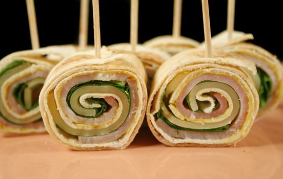 Bite size roll ups with ham, cheese and spinach.