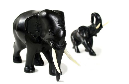 Hand carved black elephants in formation.