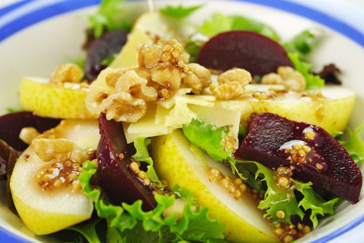 Delicious freshly made pear, beetroot and walnut salad ready to serve.