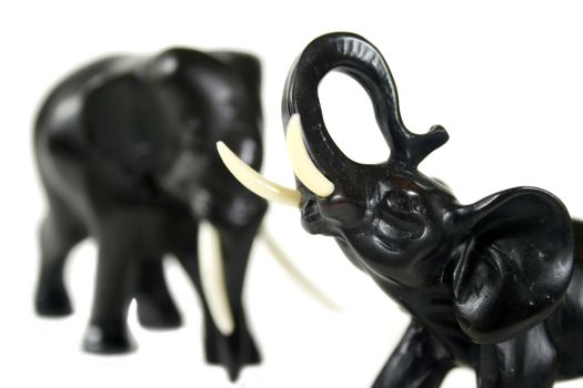Hand carved black elephants in formation.