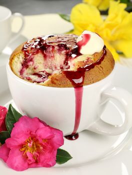 Delicious sponge pudding with blackberry sauce ready to serve.