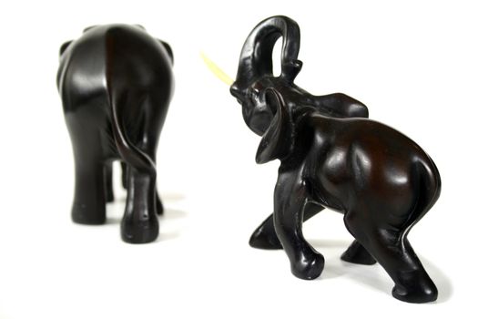 Hand carved black elephants in formation.