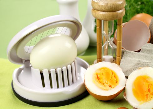 Egg slicer with boiled eggs and an egg timer.