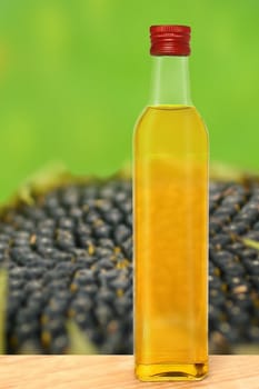Bottle of olive oil on a blurred background.