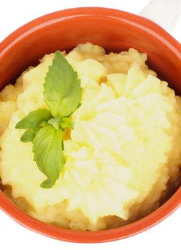 Classical Mashed Potato in Bowl Garnished with Green Basil Leafs. Top View