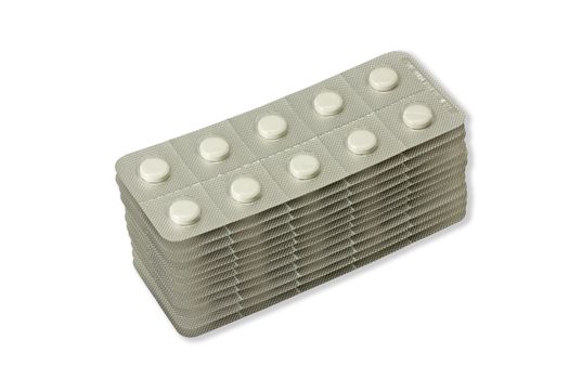 Stack of pills in blister packs on white white background