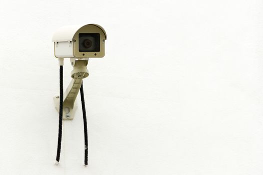 CCTV security camera on white concrete background