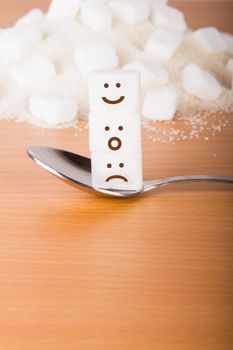 White sugar cubes, on a wooden background