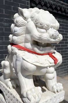 Chinese Imperial Lion Statue with a red scarf