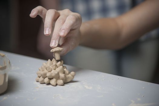 Girl make toyfrom clay. High resolution image.