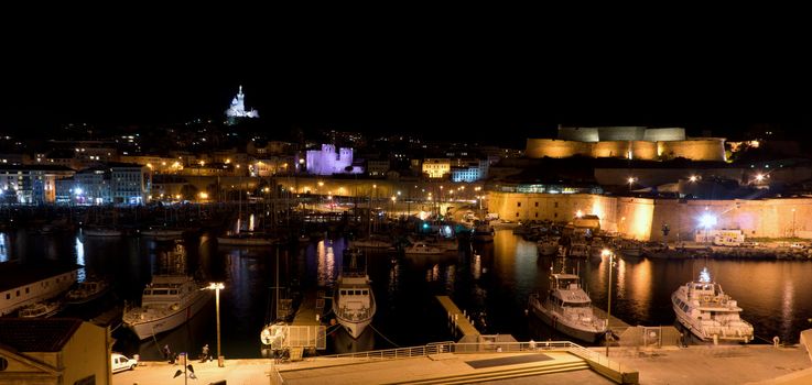 Marseille, France - 2013, November 2: A night view of the old sea port of Marseille and the Fort Saint Jean. On November 2013 in Marseille, France.