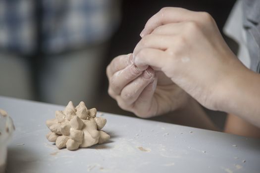 Girl make toyfrom clay. High resolution image.