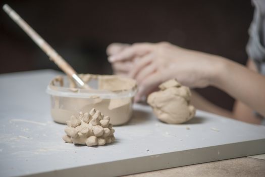 Girl make toyfrom clay. High resolution image.