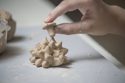 Girl make toyfrom clay. High resolution image.