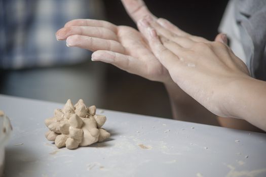 Girl make toyfrom clay. High resolution image.