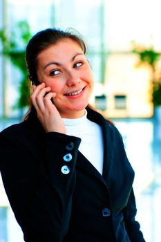 Young happy business woman talking on the phone