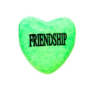 pink painted heart stone with friendship word
