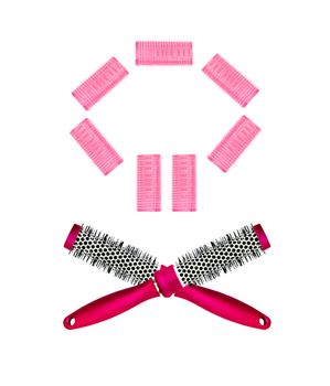 pink hairbrush and curlers isolated on white