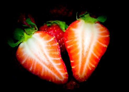 cut strawberry on a black background