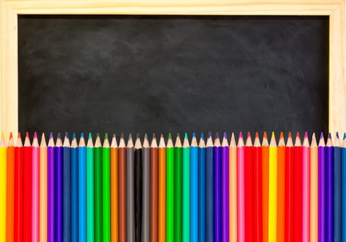 colored pencils on black chalkboard background